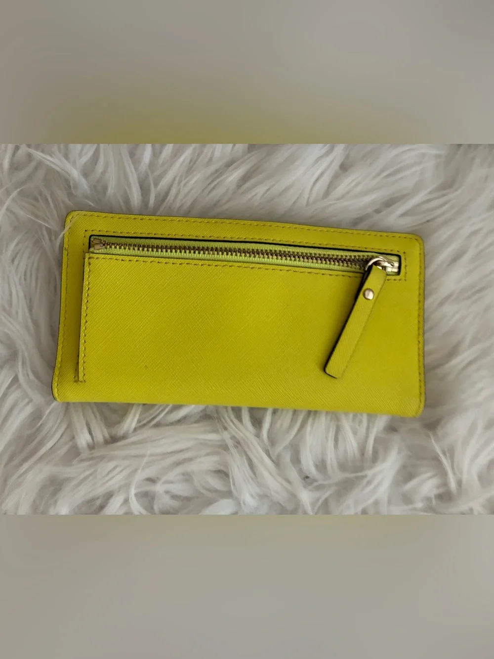 Lime green Kate Spade New York slim bifold wallet features multiple card slots